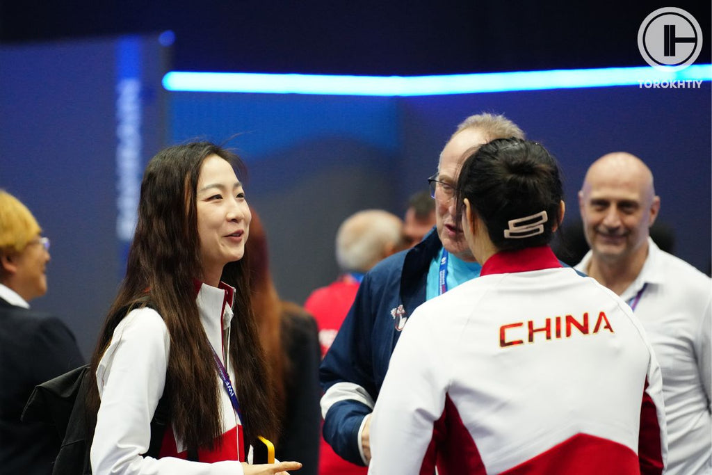 People at an event with a focus on a person wearing a 'China' jacket.