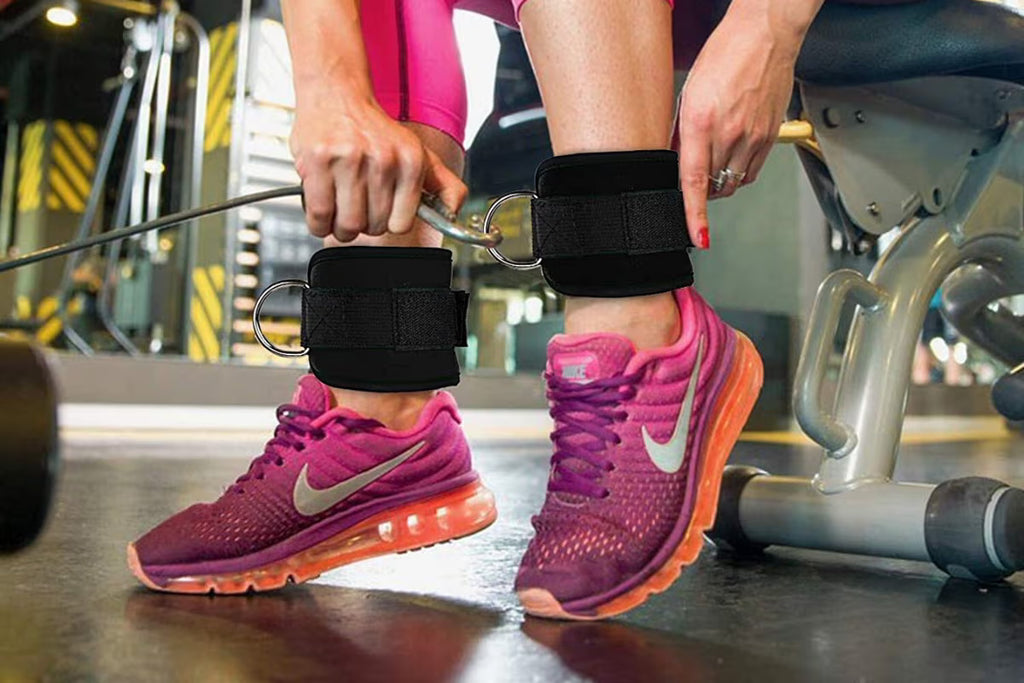 Person wearing pink athletic shoes with orange soles in a gym setting